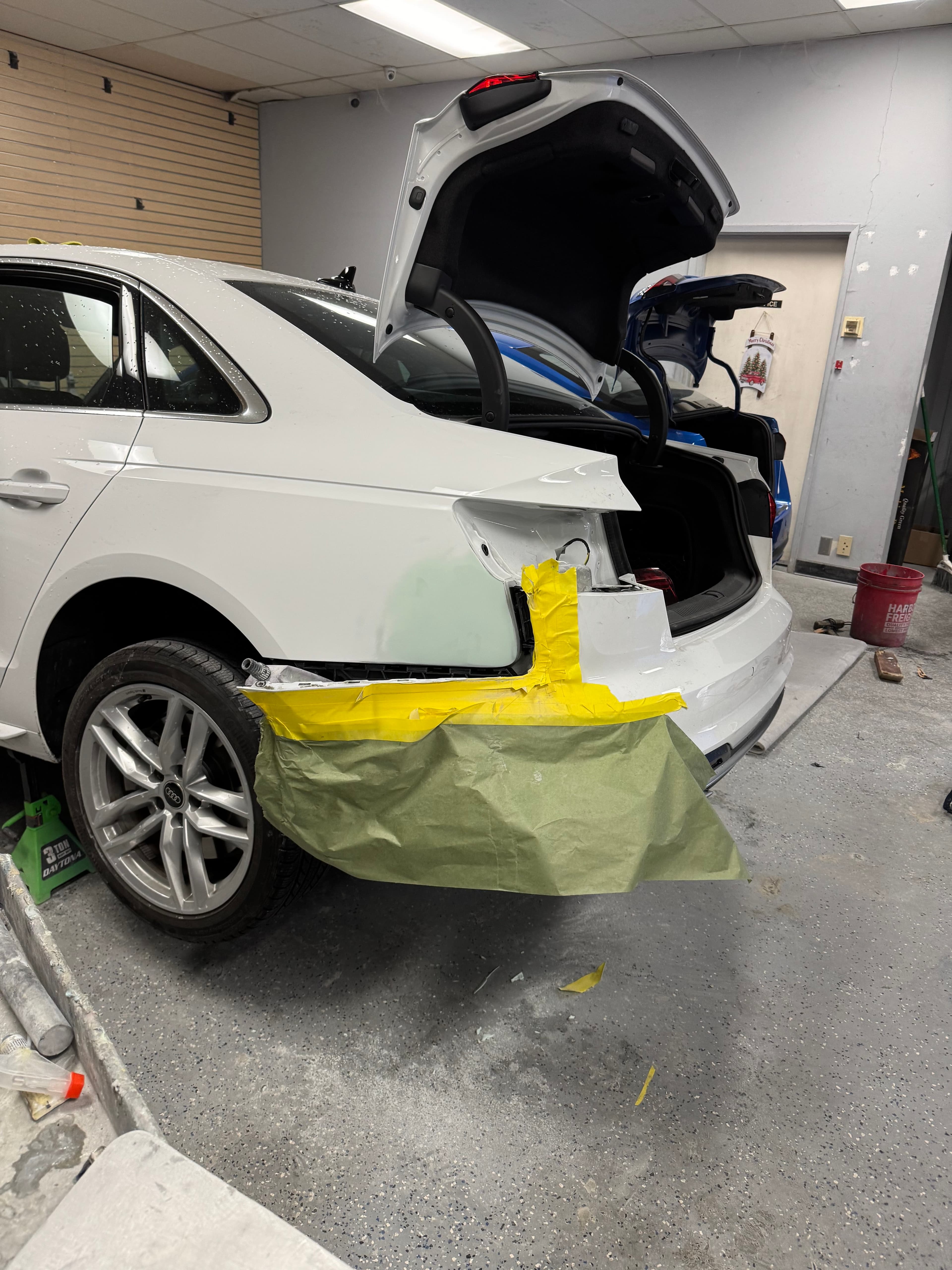White Audi sedan undergoing rear bumper repair at D&S Auto Repair in Vallejo, CA